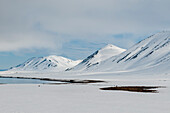 Snow layers mountains and the beach at Mushamna. Mushamna, Spitsbergen Island, Svalbard, Norway.