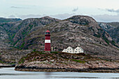 The 1917 Buholmrasa lighthouse atop a small rock island in Svesfjorden. Svesfjorden, Sor Throndelag, Norway.
