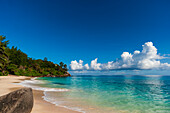 Cumulus clouds off the shore of a pristine tropical beach. Mahe Island, The Republic of Seychelles.