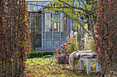 Autumn garden with garden house and seat