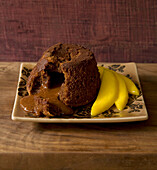 Chocolate fondant pudding with liquid center and mango slices