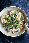 Vegan spaghetti carbonara with green asparagus