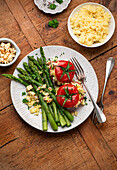 Couscous stuffed tomatoes with green asparagus