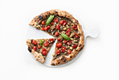 Vegetable pizza with eggplant cream, datterini tomatoes, pine nuts and basil leaves