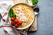 Spaghetti with cheese, tomatoes and basil