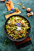 Herb spelt spiral noodles with mushrooms and Tyrolean bacon