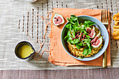 Lamb's lettuce with ham and figs on lentil dal