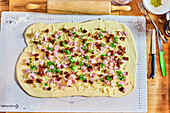 Pizza with ham, ready to bake