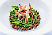Lentils with rocket, dried beef strips and white asparagus