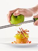 Grating apple over ice cream dessert