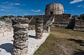 Stone columns and the Round Temple in the ruins of the Post-Classic Mayan city of Mayapan, Yucatan, Mexico.