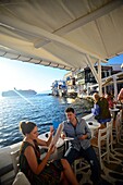 Cafe terrace with Little Venice in view, Mykonos, Greece