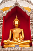 Golden Buddha statue at Wat Bupparam Buddhist temple in Chiang Mai, Thailand.