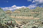 Couple hiking on trail in Blue Basin area of the Sheep Rock Unit of John Day Fossil Beds National Monument, Oregon.