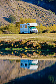 Caravan reflections, Lake Moke campsite, Queenstown, South Island, New Zealand