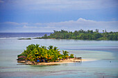 Small idyllic island Motu in Huahine island Society Islands, French Polynesia, South. Coastline and lagoon of Huahine island near Maroe bay, south Pacific ocean, Oceania