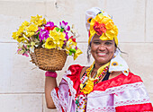 Cuban woman with traditional clothing in old Havana street. The historic center of Havana is UNESCO World Heritage Site since 1982.