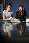 Two female scientists conducting research in a wildlife lab