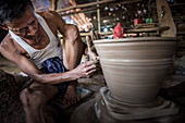Portrait of a potter in an Oh Bo pottery shed, Twante, near Yangon, Myanmar (Burma)