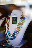 Necklace made of Murano glass with guarantee certificate in shop display window, Murano, Venice, Italy