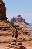 Couple hiking on Broken Arrow Trail at Chicken Point, Sedona, Arizona.