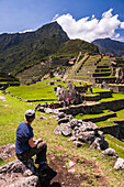 Tourists sightseeing at Machu Picchu Inca Ruins, Cusco Region, Peru