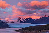 A colorful sunrise over the Perito Moreno Glacier in Los Glaciares National Park near El Calafate, Argentina. A UNESCO World Heritage Site in the Patagonia region of South America.