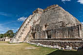 The west side of the Pyramid of the Magician faces the Quadrangle of the Birds in the ruins of the Mayan city of Uxmal in Yucatan, Mexico. Pre-Hispanic Town of Uxmal - a UNESCO World Heritage Center.