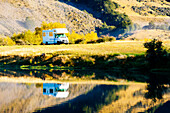 Caravan parked at autumnal Lake Moke campsite, Queenstown, South Island, New Zealand