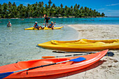 Kayaking in Taha'a island beach, French Polynesia. Motu Mahana palm trees at the beach, Taha'a, Society Islands, French Polynesia, South Pacific.