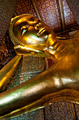 The Reclining Buddha at Wat Pho, the largest Buddhist temple in Bangkok, Thailand, and birthplace of Thai massage.