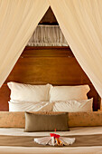 Bed in guest bure "Lima" at Matangi Private Island Resort, Fiji.