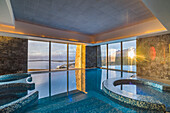 Indoor swimming pool area at sunset at Hotel Arakur Ushuaia Resort and Spa at Ushuaia, Tierra del Fuego, Patagonia, Argentina