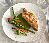 Fresh, locally purchased Mahi-mahi with herbal butter basil and parsley, accompanied by roasted vegetables at Hector's Kitchen in Punta de Mita, Riviera Nayarit, Mexico.