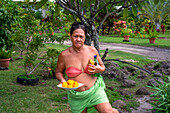 Woman Cutting Mango Fruit with Sharp Knife in Moorea, French Polynesia, Society Islands, South Pacific. Cook's Bay.