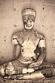 Ancient Buddha statue at Wat Chaiwatthanaram Buddhist temple ruins in Ayutthaya, Thailand.