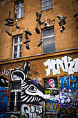 Metelkova, graffiti and shoes hanging from wires, Ljubljana, Slovenia, Europe