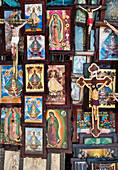 Religiöse Gemälde und Figuren des gekreuzigten Christus werden auf dem Platz vor der Kirche Unserer Lieben Frau von San Juan de los Lagos in der Stadt San Juan de los Lagos, Jalisco, Mexiko, zum Verkauf angeboten.