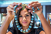 Woman seller in Tahia Exquisite Tahitian Pearls shop in Papeete, Tahiti, French Polynesia, Tahiti Nui, Society Islands, French Polynesia, South Pacific.