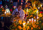 Mexican woman in a cemetery during Day of the Dead in Oaxaca, Mexico