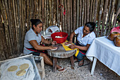Two Mayan women making fresh tortillas by hand in a restaurant in Valladolid, Yucatan, Mexico.