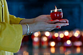 Woman at Buddhist ceremony praying with a candle, Huynh Dao Buddhist temple, Chau Doc, Vietnam, Indochina, Southeast Asia, Asia