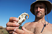 Man Holding A Porcupine Skull