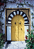 Black And White Arched Doorway With Yellow Doors.