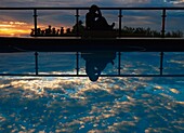 Woman Reflected In Swimming Pool At Dusk