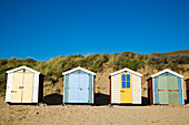 Beach Huts Lined Up In Front Of A Dune On Saunton Sands Beach
