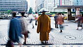 Monk And Pedestrians Outside Shinjuku Station, Blurred Motion