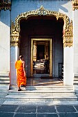 Buddhist Monk Walking Through Doorway Of Wat Benchamabophit