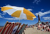 Beach With Umbrella And Deck Chairs