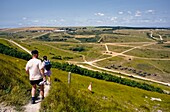 Hikers On Path Through Firing Ranges, Rear View